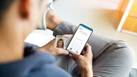 Young man enters his ID PIN on his smartphone